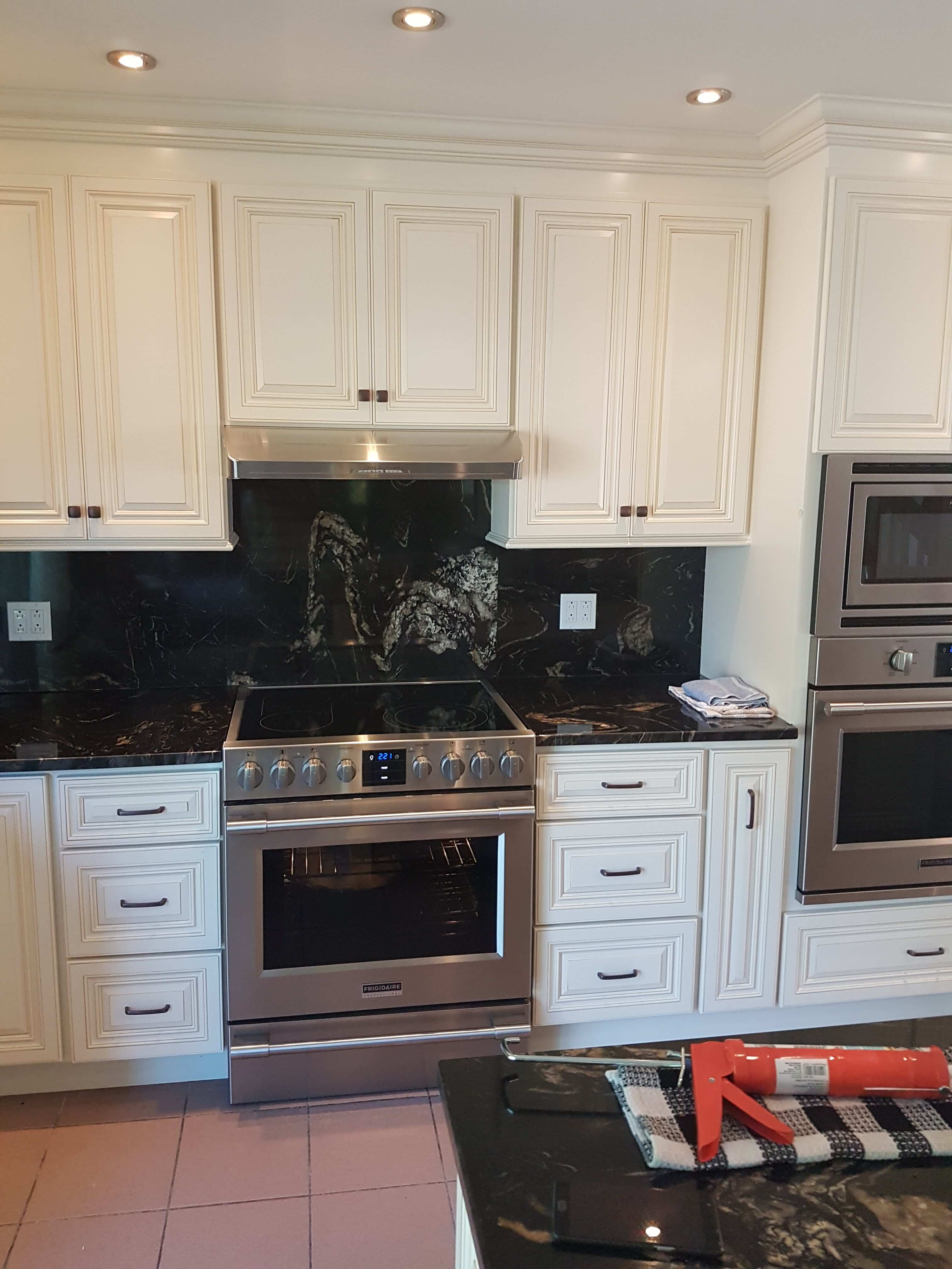 wheaton white kitchen cabinets and black marble backsplash