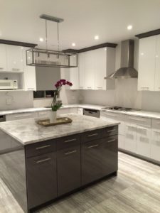 a beautiful white marble kitchen and brown cabinets